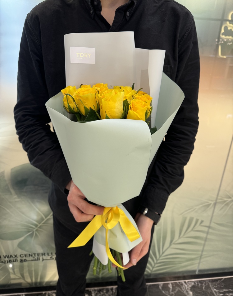bouquet of 11 yellow roses in a packaging
